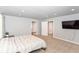 Large bedroom with neutral walls, plush carpet, and multiple doors leading to other rooms or closets at 1302 Main St, Elwood, IN 46036
