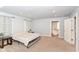 A spacious bedroom boasts plush carpeting, ensuite bathroom, and large windows for natural light at 1302 Main St, Elwood, IN 46036