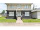Charming two-story home featuring a welcoming front porch and well-maintained lawn at 1302 Main St, Elwood, IN 46036