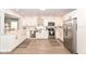 Modern kitchen with white cabinets, stainless steel appliances, stone countertops and wood floor at 1302 Main St, Elwood, IN 46036