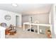 Upstairs hallway with chair, a large window, carpeted floors, and a chandelier at 1302 Main St, Elwood, IN 46036