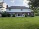 The spacious backyard features a lush lawn, patio and brick exterior with white siding at 13221 Griffin Run, Carmel, IN 46033