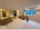 Large finished basement with built-in shelving, comfortable seating, and natural light at 13221 Griffin Run, Carmel, IN 46033