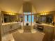 Luxurious bathroom with double sinks, jacuzzi, and shuttered windows at 13221 Griffin Run, Carmel, IN 46033