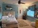 Cozy bedroom featuring soft blue walls, a comfortable bed, and natural light at 13221 Griffin Run, Carmel, IN 46033