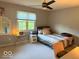 Well-lit bedroom featuring a ceiling fan, a window and neutral decor at 13221 Griffin Run, Carmel, IN 46033