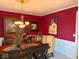 Elegant dining area features a dark wood table and chandelier at 13221 Griffin Run, Carmel, IN 46033