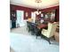Spacious dining room with a large wood table, seating for eight, white trim, and natural light from shuttered windows at 13221 Griffin Run, Carmel, IN 46033