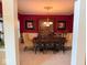 Formal dining room featuring vibrant red walls and a classic chandelier at 13221 Griffin Run, Carmel, IN 46033