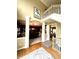 Welcoming foyer with hardwood floors, showcasing the staircase with white trim and open access to dining and living areas at 13221 Griffin Run, Carmel, IN 46033