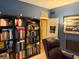 Comfortable home office with built-in bookshelves and a leather armchair at 13221 Griffin Run, Carmel, IN 46033