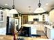 Beautiful kitchen featuring white cabinets, stainless steel appliances, and an island with bar stool seating at 13221 Griffin Run, Carmel, IN 46033