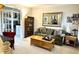 Comfortable seating area with a stylish coffee table, bookcase, and large mirror at 13221 Griffin Run, Carmel, IN 46033