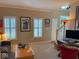 Bright living room features a computer workstation, natural light, and easy access to staircase at 13221 Griffin Run, Carmel, IN 46033
