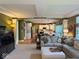 Open living room showcases arched doorway to kitchen, neutral color palette, plush seating and seamless flow at 13221 Griffin Run, Carmel, IN 46033