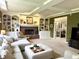 Spacious living room with a cozy fireplace, built-in shelving, and comfortable seating arrangements at 13221 Griffin Run, Carmel, IN 46033