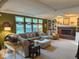 Inviting living room with brick fireplace, built-in shelving, large windows, neutral tones and plush seating at 13221 Griffin Run, Carmel, IN 46033
