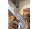Elegant staircase with white banisters, wooden handrail, and a decorative console table at 13221 Griffin Run, Carmel, IN 46033