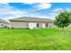 Well-maintained backyard featuring a sliding glass door and concrete patio at 1331 Mccormicks Cir, Danville, IN 46122