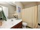 Bright bathroom with a white sink and vanity, shower with yellow curtain, and neutral walls at 1331 Mccormicks Cir, Danville, IN 46122
