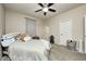 Comfortable bedroom with ceiling fan, carpet, and a large bed with decorative pillows at 1331 Mccormicks Cir, Danville, IN 46122