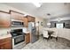 Eat-in kitchen with stainless appliances that opens up to the dining and living room at 1331 Mccormicks Cir, Danville, IN 46122