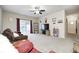 Spacious living room with sliding door to backyard and ceiling fan at 1331 Mccormicks Cir, Danville, IN 46122