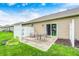 Backyard patio area with outdoor seating and sliding glass doors to the home's interior at 1331 Mccormicks Cir, Danville, IN 46122
