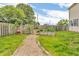 A gravel path leads through a garden area with raised beds in a spacious backyard at 1357 Brownswood Dr, Brownsburg, IN 46112