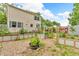 Landscaped backyard featuring a vegetable garden, patio, and deck, perfect for outdoor living at 1357 Brownswood Dr, Brownsburg, IN 46112