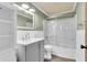 Bathroom with a shower-tub combo, updated vanity and light fixtures, and decorative shiplap at 1357 Brownswood Dr, Brownsburg, IN 46112