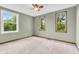 Bright bedroom with neutral carpet, a ceiling fan, and three windows offering ample natural light at 1357 Brownswood Dr, Brownsburg, IN 46112