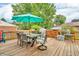 Relaxing deck area featuring a dining table with an umbrella and a charming outdoor setting at 1357 Brownswood Dr, Brownsburg, IN 46112