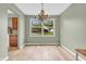 Bright dining room with hardwood floors and a charming chandelier fixture at 1357 Brownswood Dr, Brownsburg, IN 46112