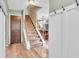 Bright foyer with stairs leading up, coat closet and light wood-look vinyl floors at 1357 Brownswood Dr, Brownsburg, IN 46112