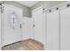 White paneled entry featuring white door and light wood-look vinyl floors at 1357 Brownswood Dr, Brownsburg, IN 46112