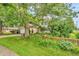 Exterior of a home with mature trees and green shutters at 1357 Brownswood Dr, Brownsburg, IN 46112