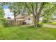 Home exterior with a driveway, a front yard, mature trees, and a basketball hoop at 1357 Brownswood Dr, Brownsburg, IN 46112