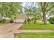Home exterior with a driveway, a front yard, mature trees, and green shutters at 1357 Brownswood Dr, Brownsburg, IN 46112