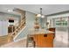 Open kitchen layout showcasing a granite island with seating, stainless steel appliances, and wood cabinets at 1357 Brownswood Dr, Brownsburg, IN 46112