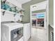 Modern laundry room with new appliances and view to outdoor deck at 1357 Brownswood Dr, Brownsburg, IN 46112