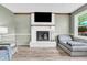Cozy living room with a white brick fireplace and a flat screen television above the mantel at 1357 Brownswood Dr, Brownsburg, IN 46112