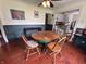 Cozy dining room featuring hardwood floors, a round table, adjacent kitchen, and bright colors at 1433 N Colorado Ave, Indianapolis, IN 46201