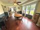 Dining room featuring hardwood floors, a round table, decorative windows, and adjacent kitchen at 1433 N Colorado Ave, Indianapolis, IN 46201
