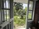 Open front door and screen revealing the yard of the home at 1433 N Colorado Ave, Indianapolis, IN 46201