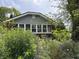 Charming home with a well-manicured yard featuring lush greenery and a variety of colorful flowers at 1433 N Colorado Ave, Indianapolis, IN 46201