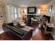 Cozy living room with hardwood floors, leather couch, stone hearth, and built-in shelving at 1433 N Colorado Ave, Indianapolis, IN 46201