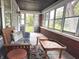 Inviting sun porch with ample seating, rug, coffee tables, and a wall of windows at 1433 N Colorado Ave, Indianapolis, IN 46201