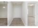 Bright entryway with wood-look flooring, white walls, and a glimpse of a carpeted bedroom at 15388 Dry Creek Rd, Noblesville, IN 46060