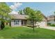 Inviting home exterior with green lawn, mature tree, and a two-car attached garage at 15388 Dry Creek Rd, Noblesville, IN 46060